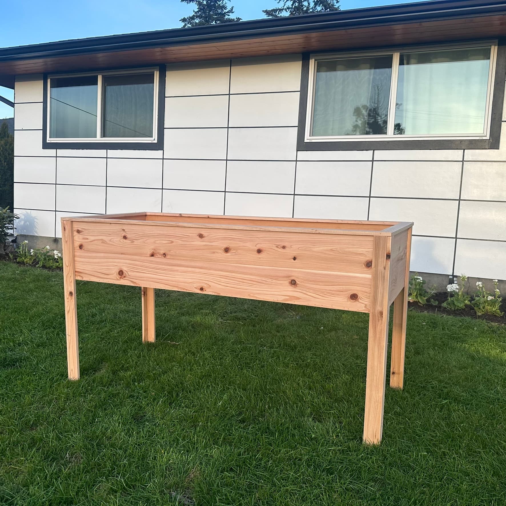 Tall standing-height cedar raised garden bed with long legs, front view on lawn
